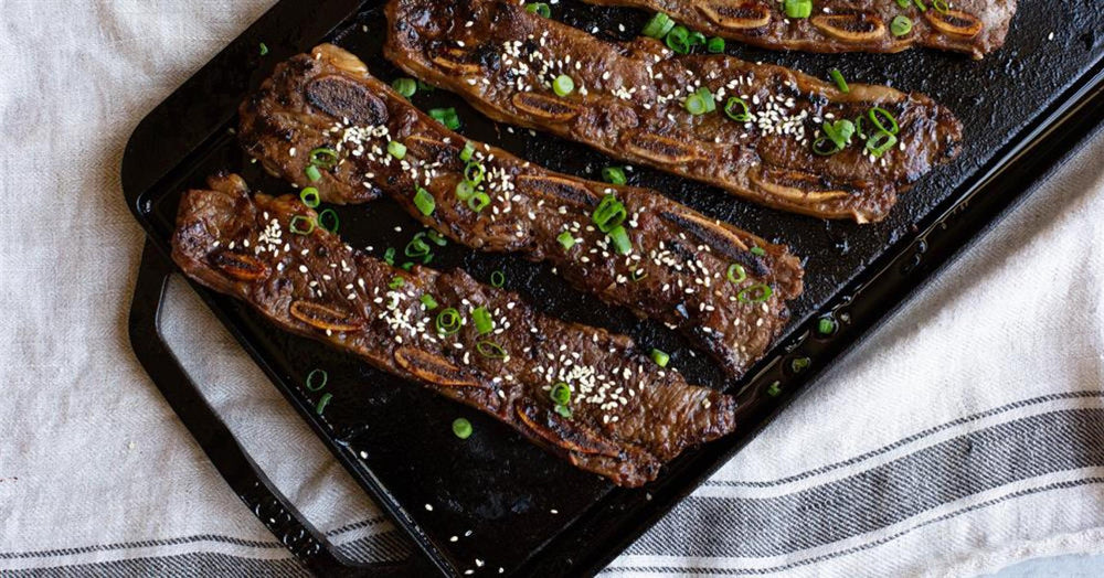 Korean BBQ Ribs garnished with sesame seeds and green onions