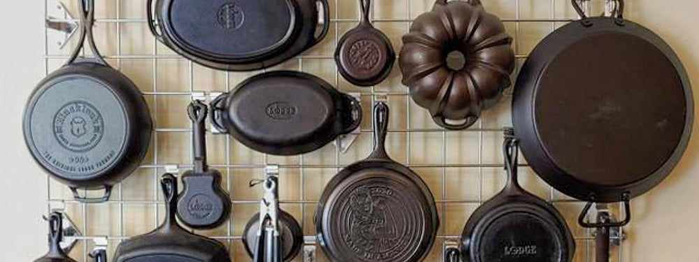Cast iron pans hanging from wire rack