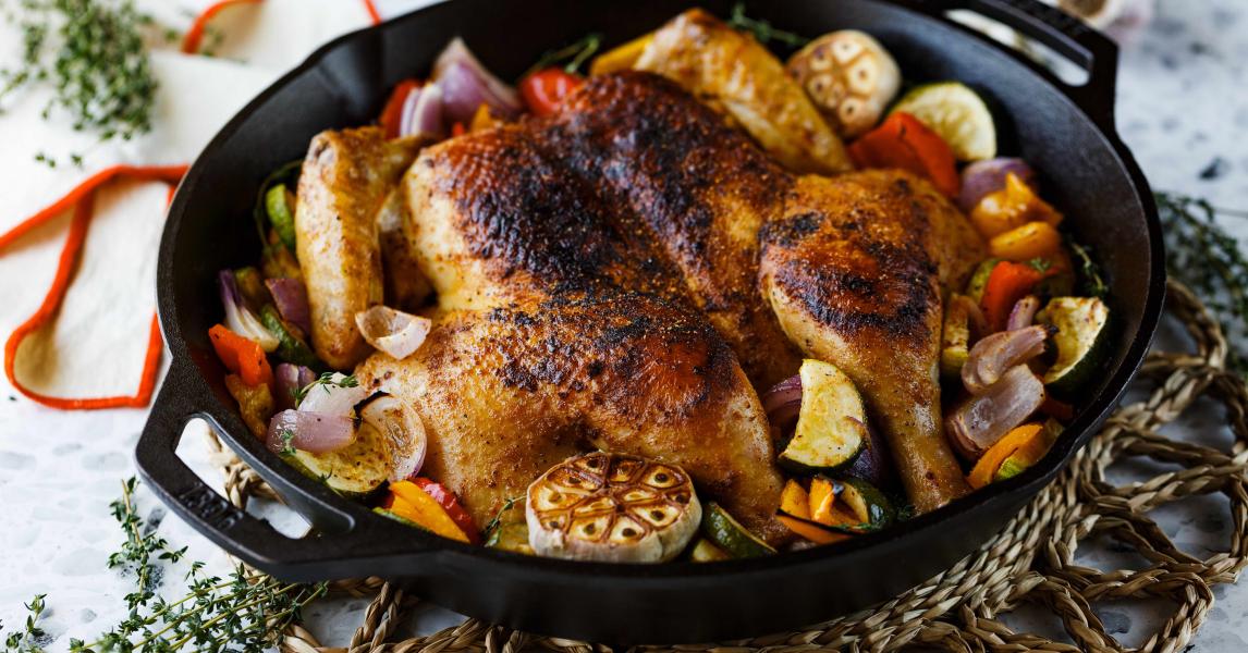 Chicken served in skillet on table.