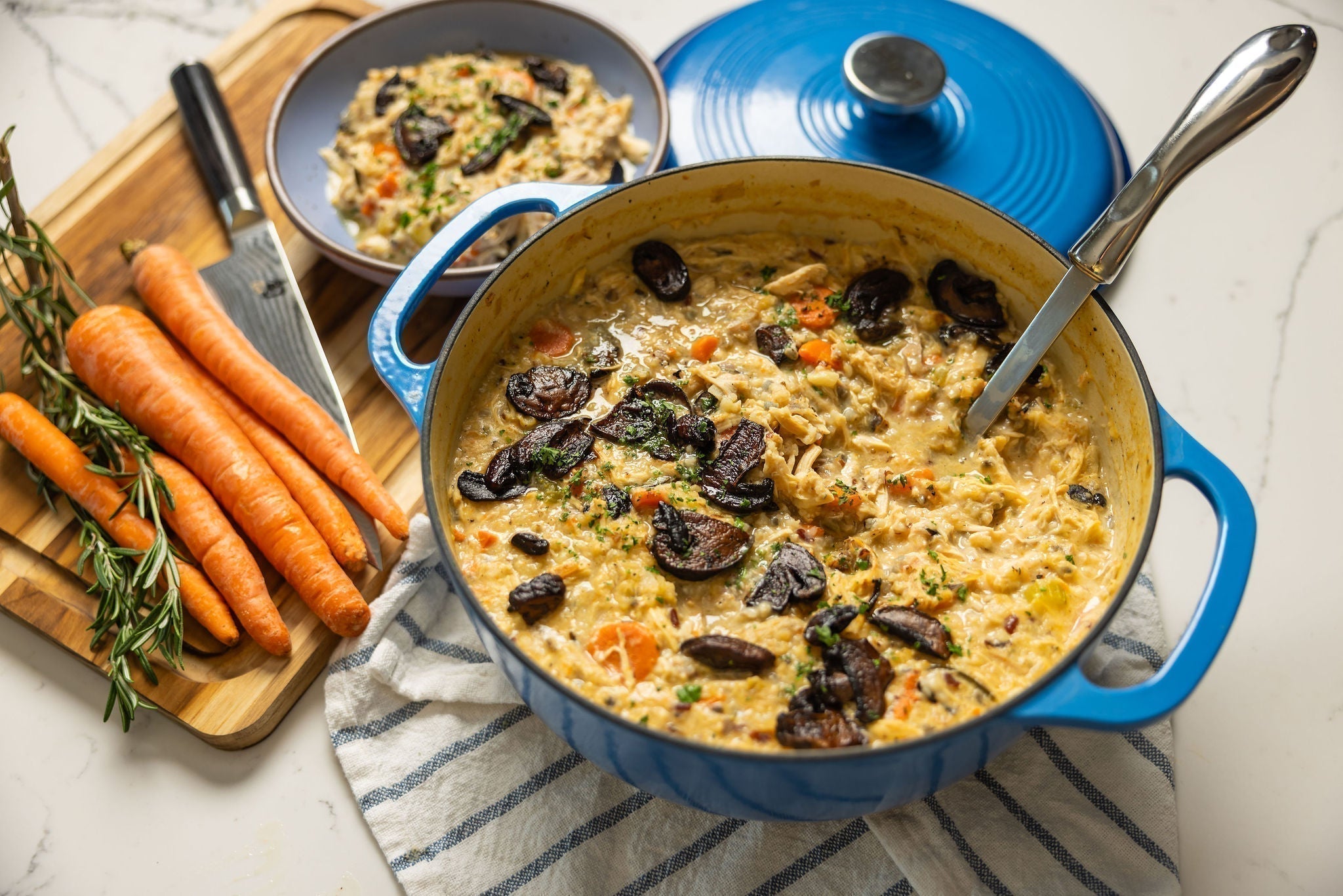 Chicekn & wild rice soup served from dutch oven with carrots