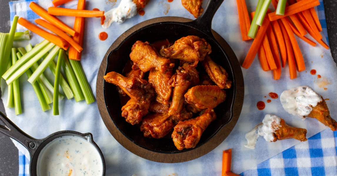 Hot wings served on table with carrots, celery, and ranch