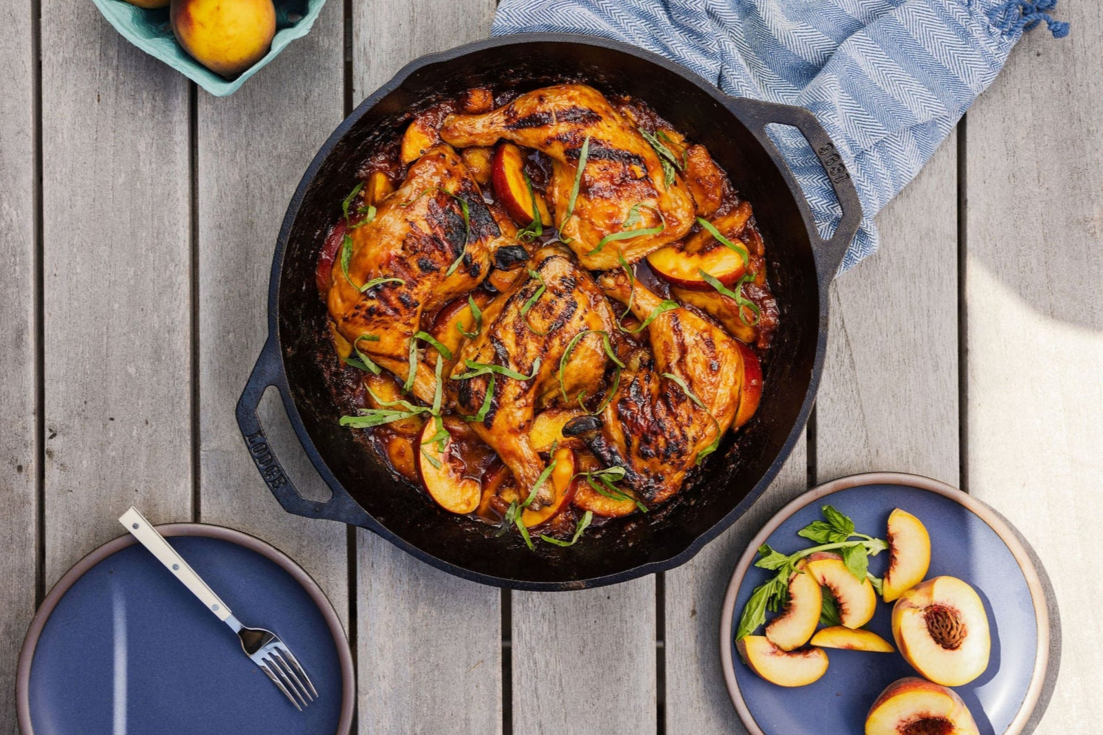 Chicken meal served on table alongside fresh peaches.