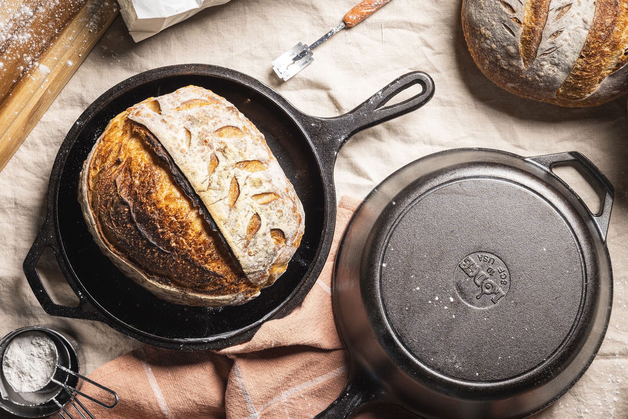 Fresh sourdough bread presented in combo cooker skillet.