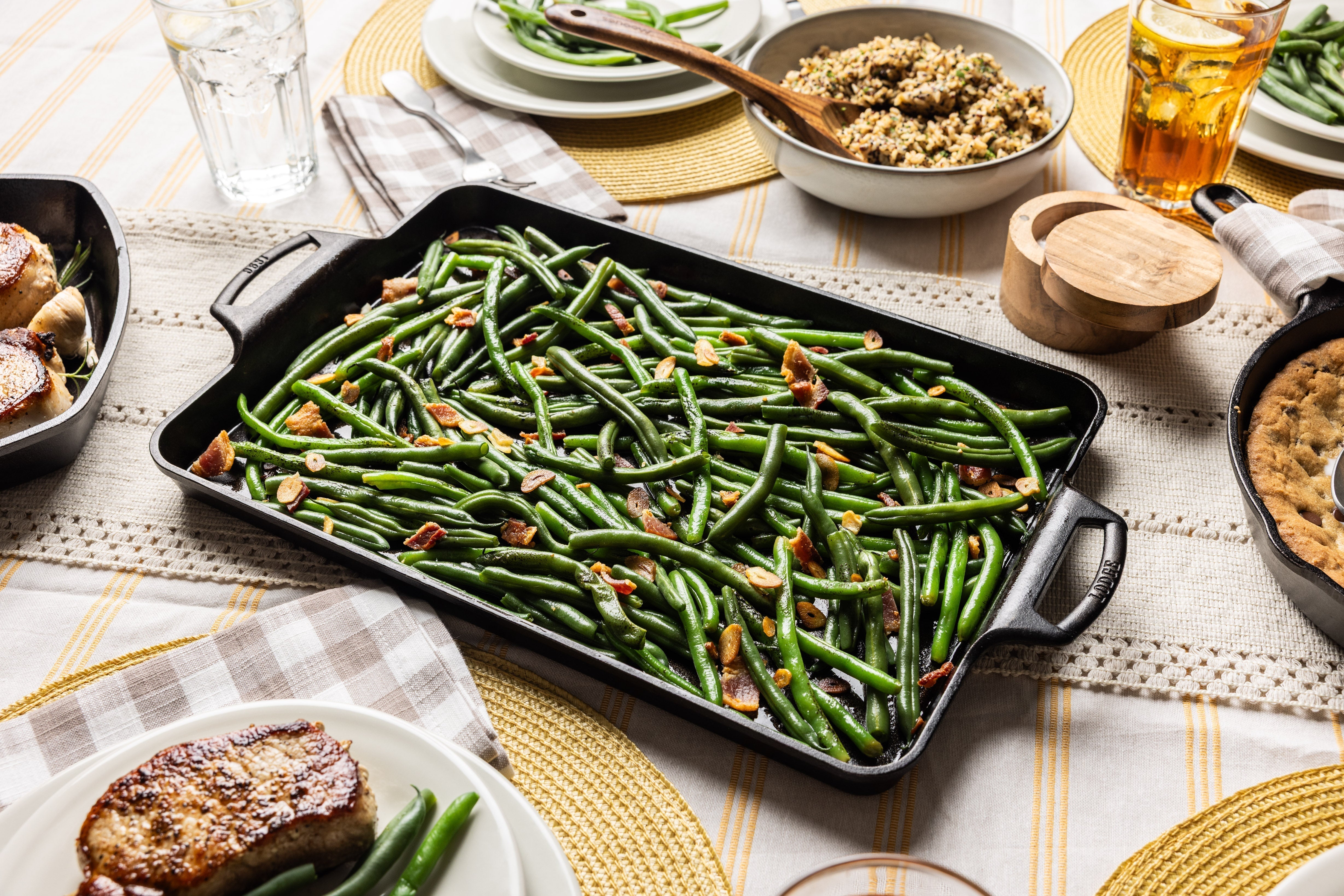 Herbed green beans prepared and served in cast iron pan.