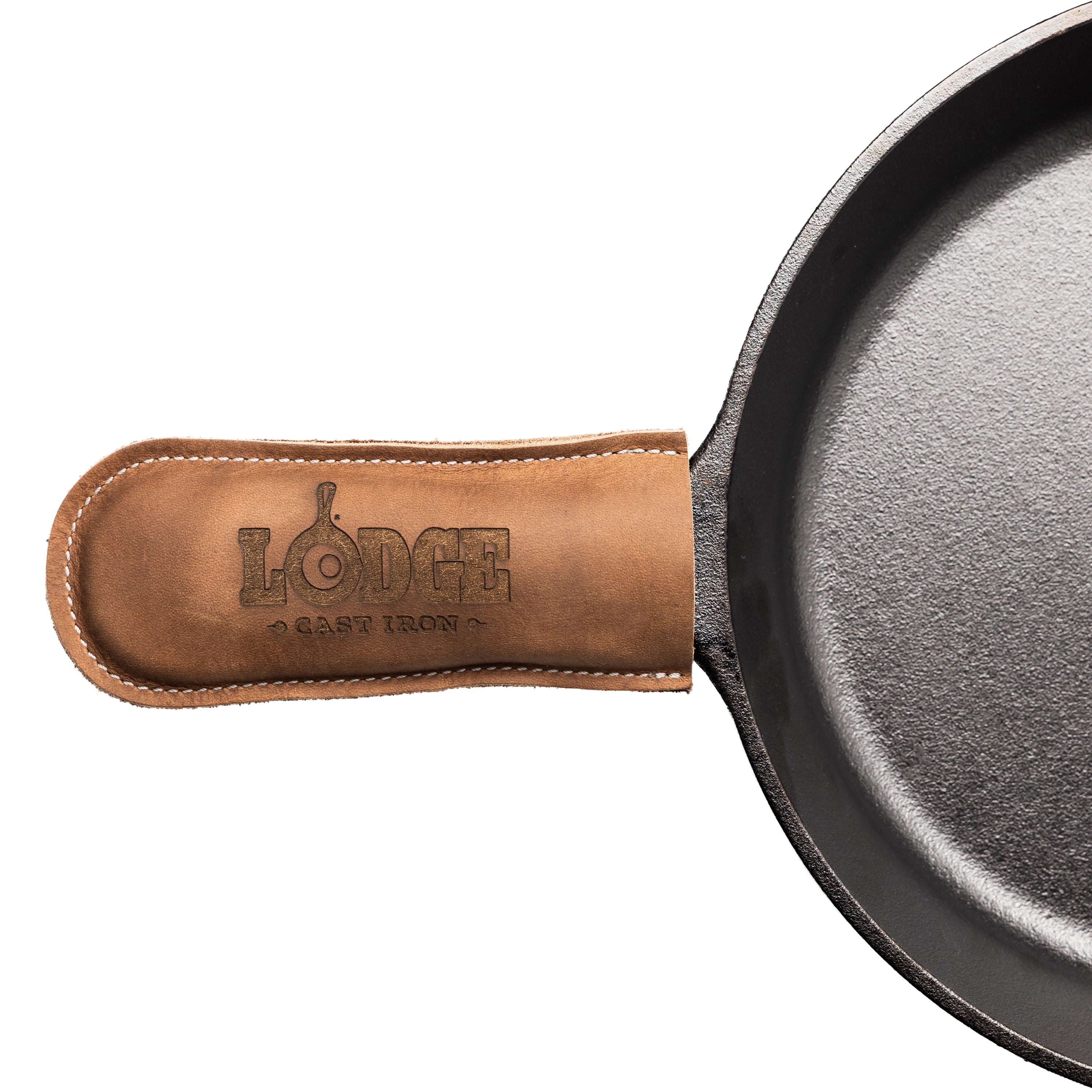 Close-up of a cast iron skillet handle covered with a tan leather sleeve embossed with the Lodge Cast Iron logo, on a white background.