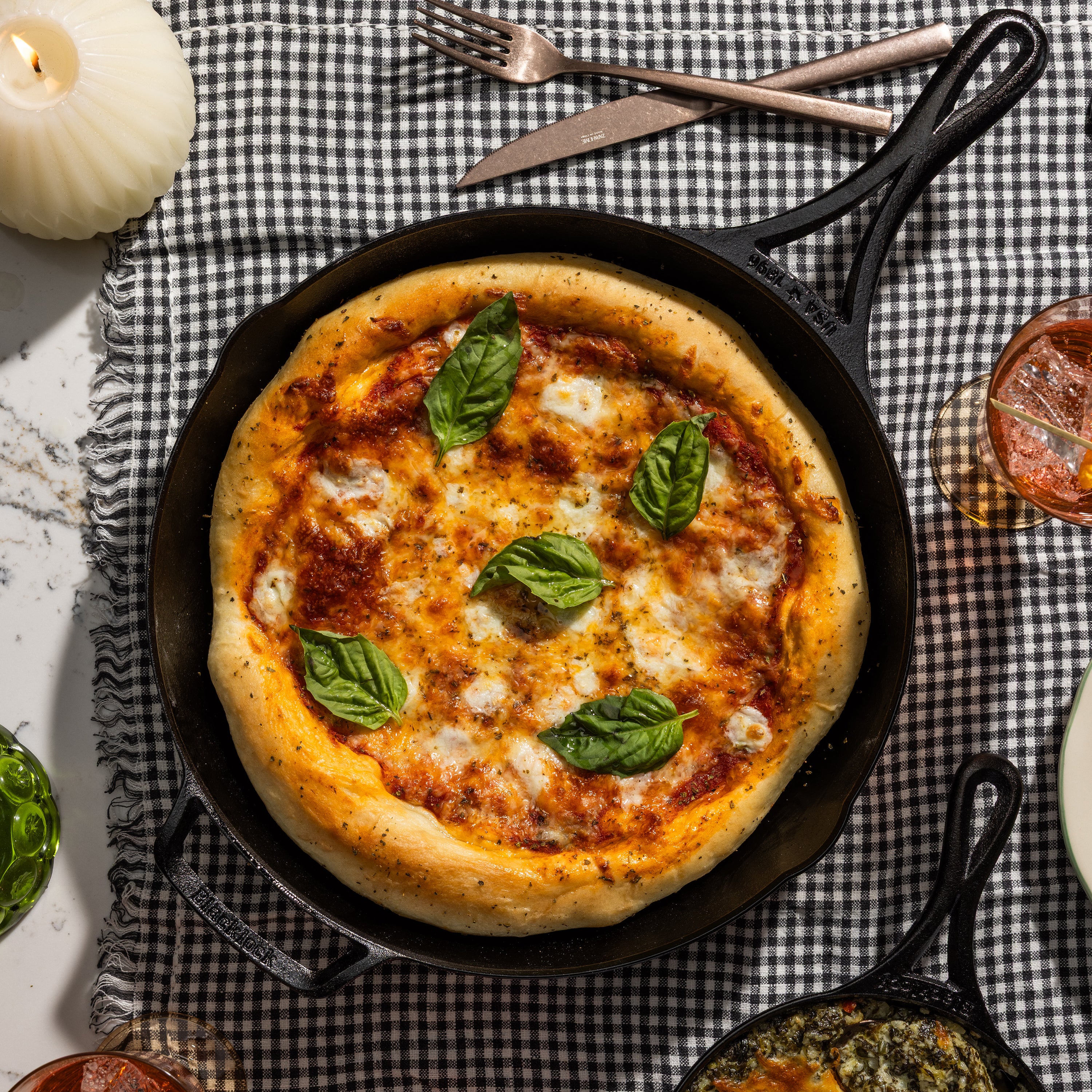 Freshly made pizza, prepared and served in skillet.