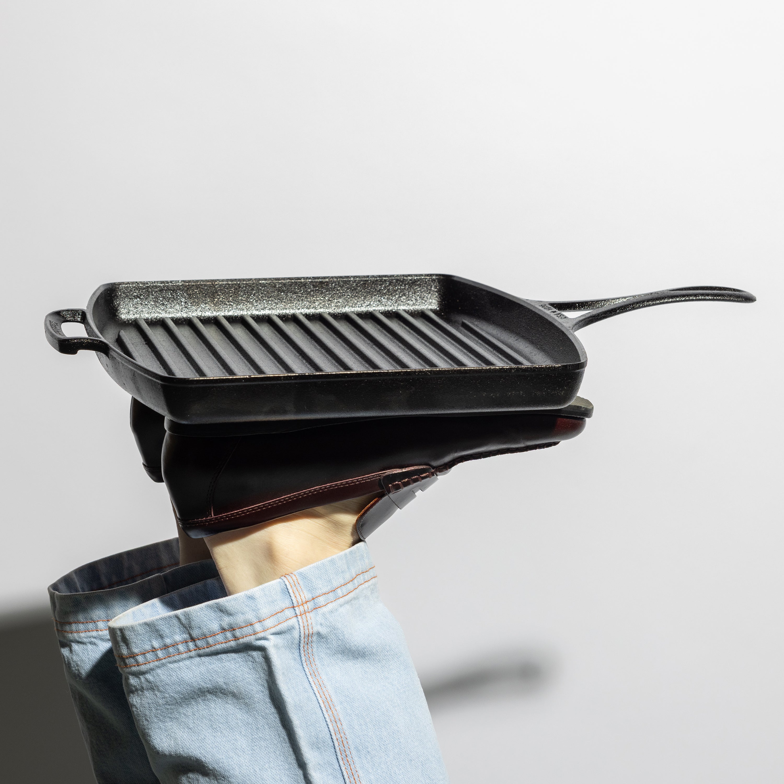 Someone propping up grill pan with feet.