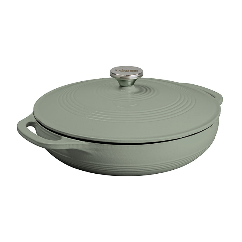 A green enameled cast iron casserole dish with a lid and handle.