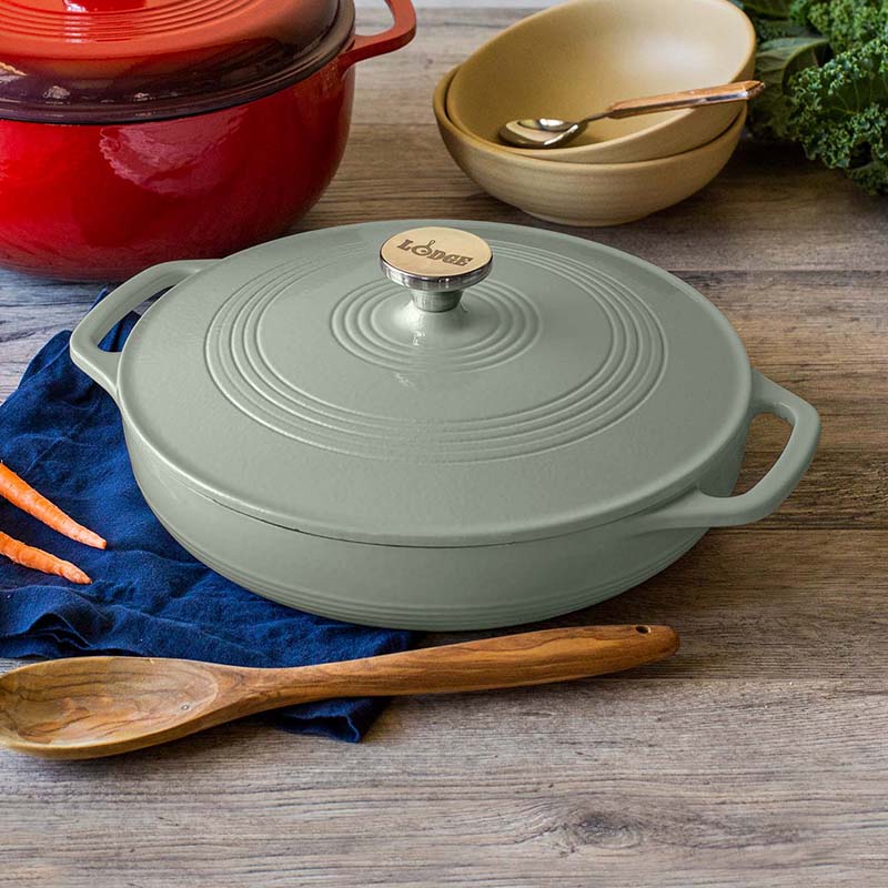 Braiser on kitchen table with other cooking utensils.