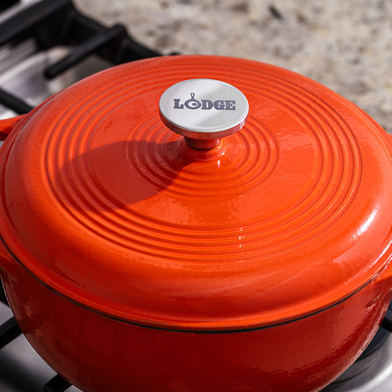 Close up of lid featuring silver knob with Lodge branding.