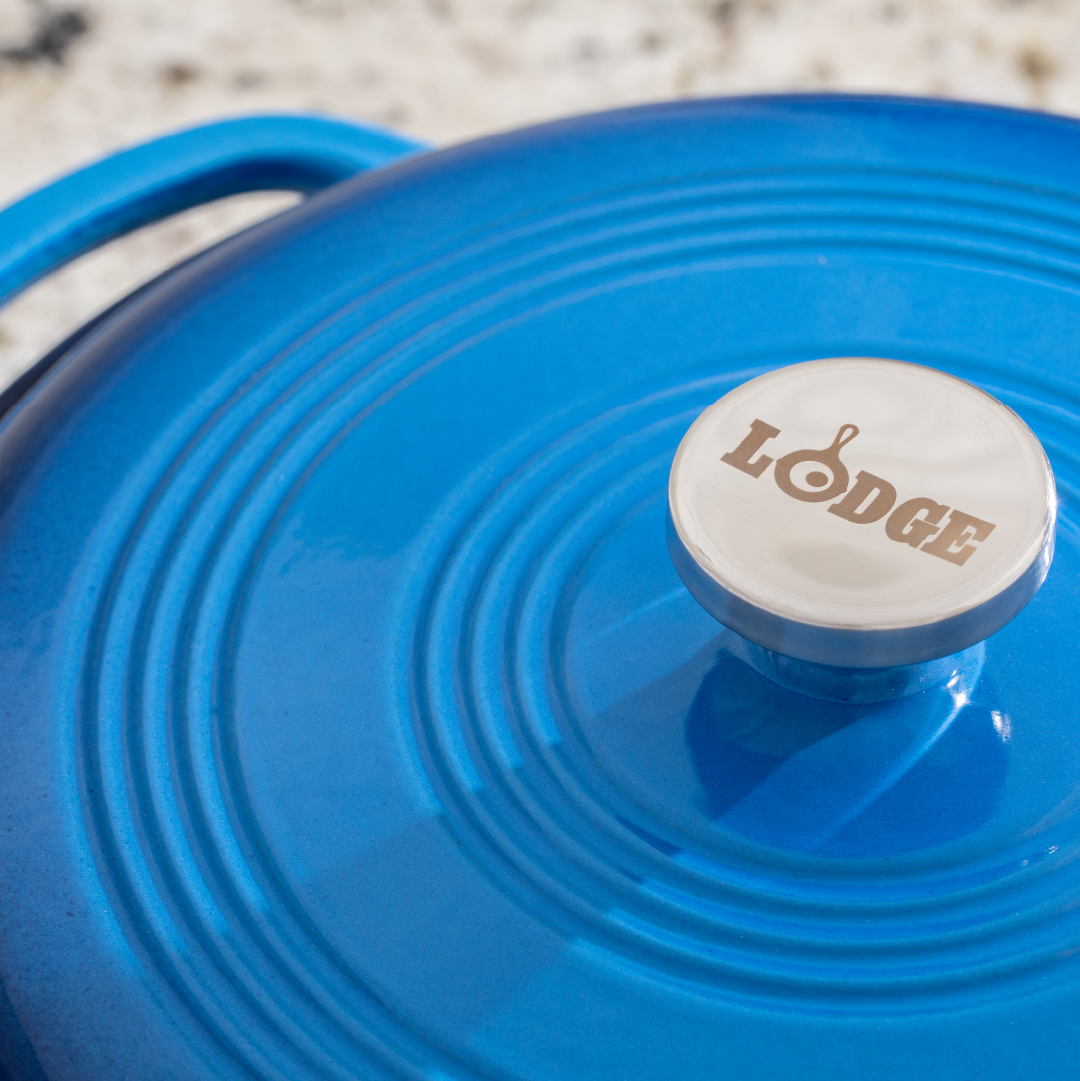 Close up of lid featuring silver knob with Lodge branding.