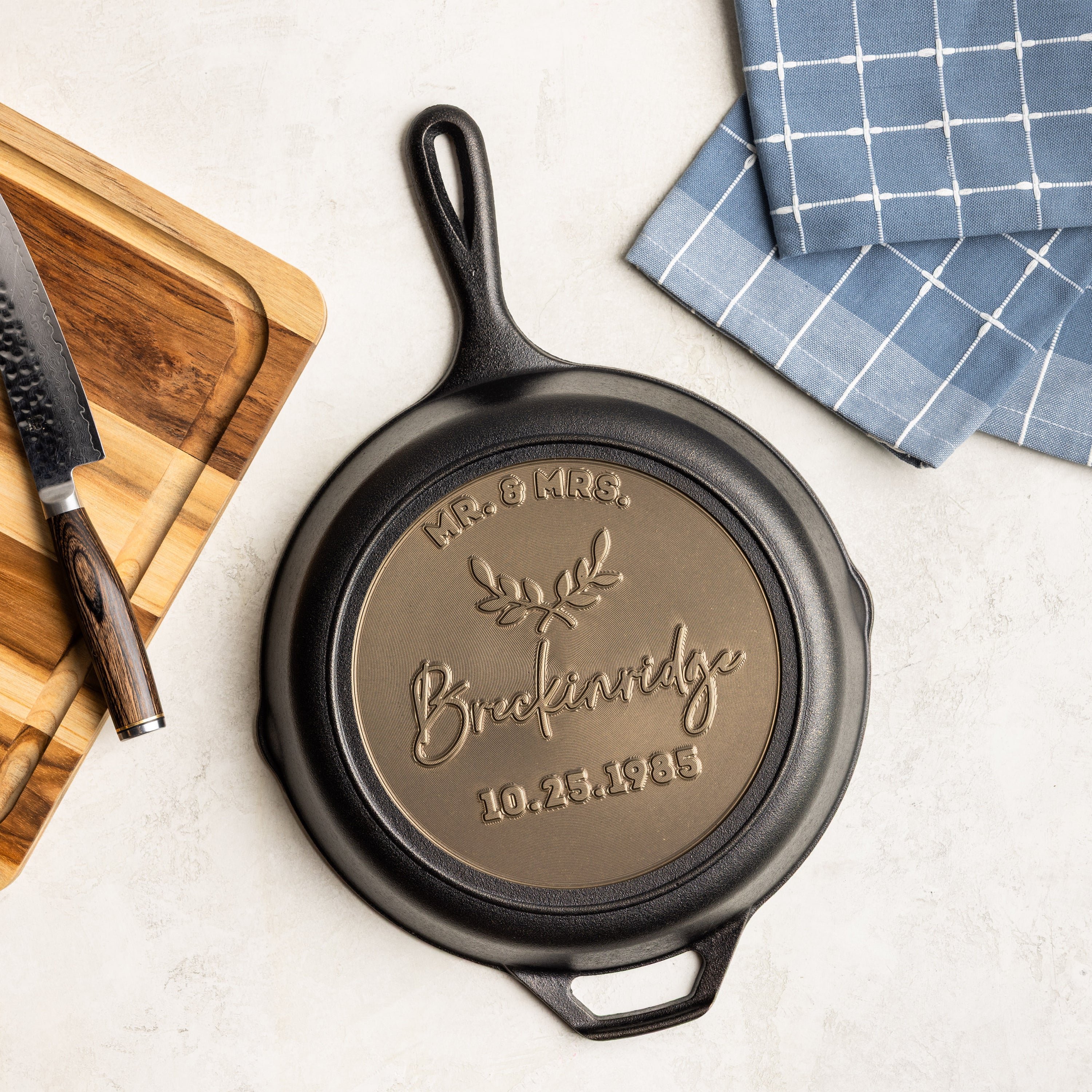 Cast iron skillet with personalized engraving on a kitchen counter