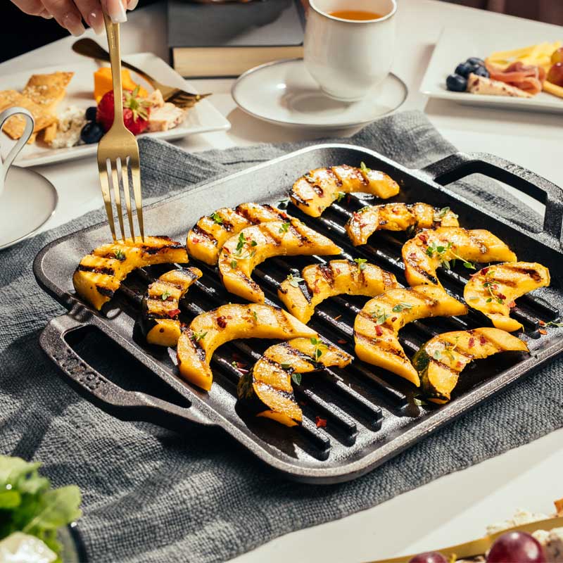 Squash freshly grilled on pan and served on kitchen table.