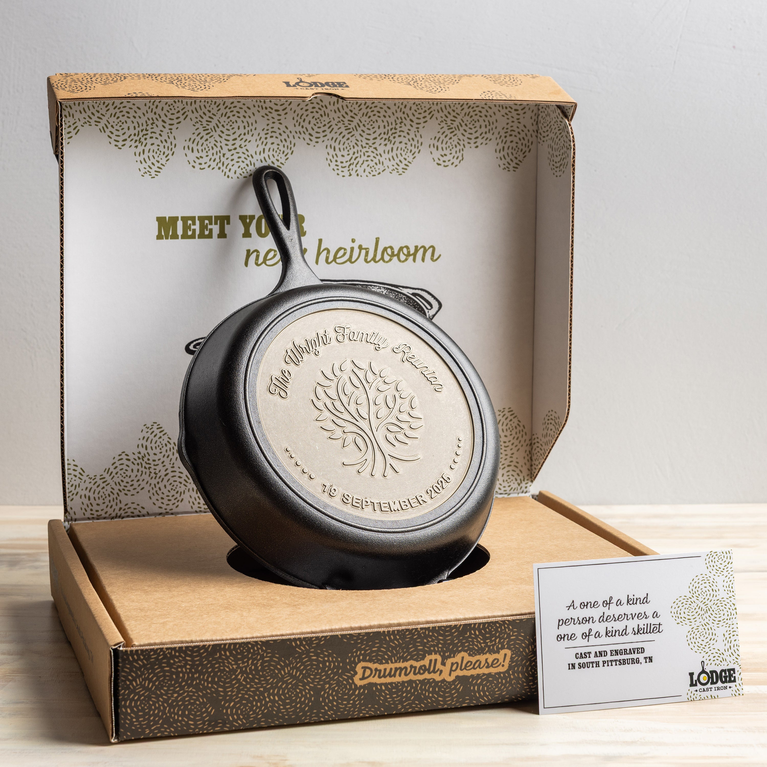 Cast iron skillet in a decorative box with branding and text
