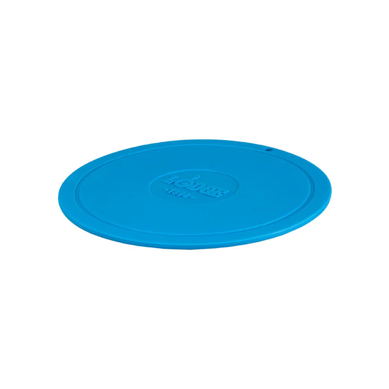 Blue circular trivet with Lodge branding in center.
