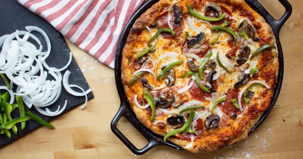 Pizza topped with green peppers and onions.