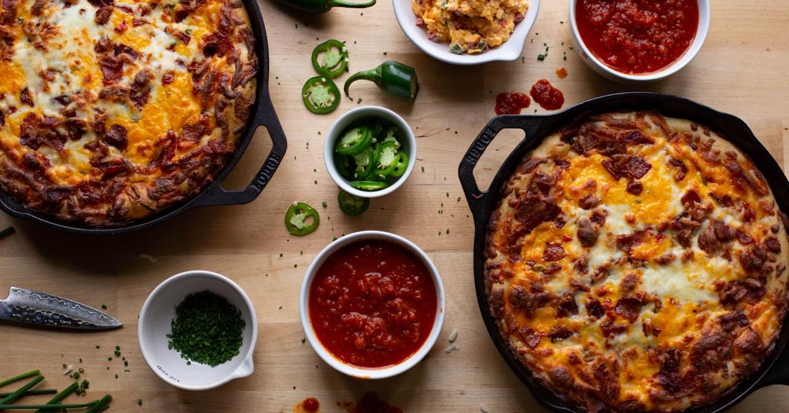 Bacon and Pimento Cheese Pizza served with sides of sauce and jalapenos.