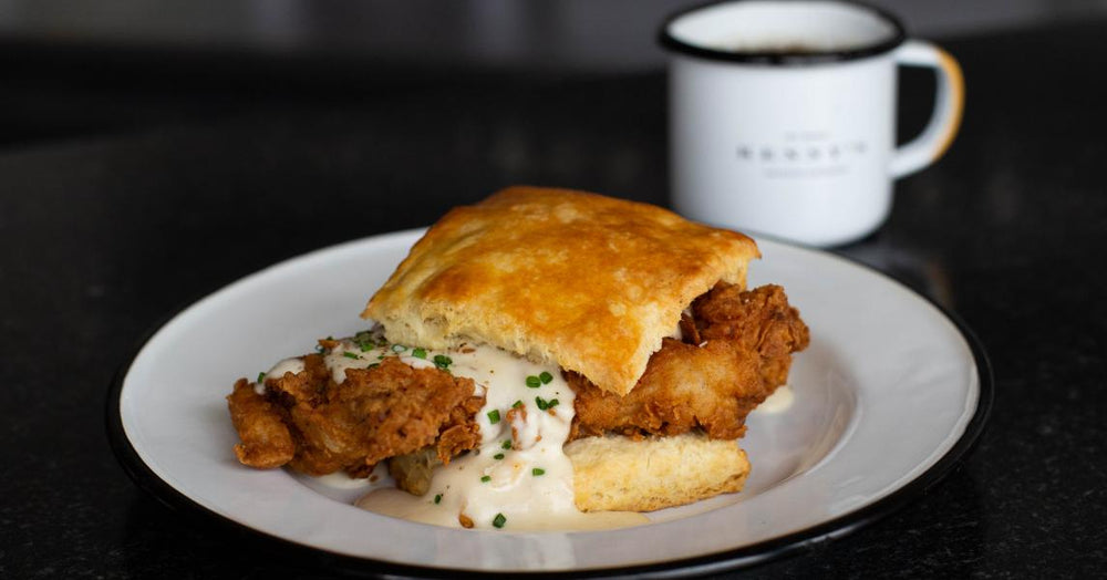 Kenny's Country Gravy served with a biscuit and fried chicken.