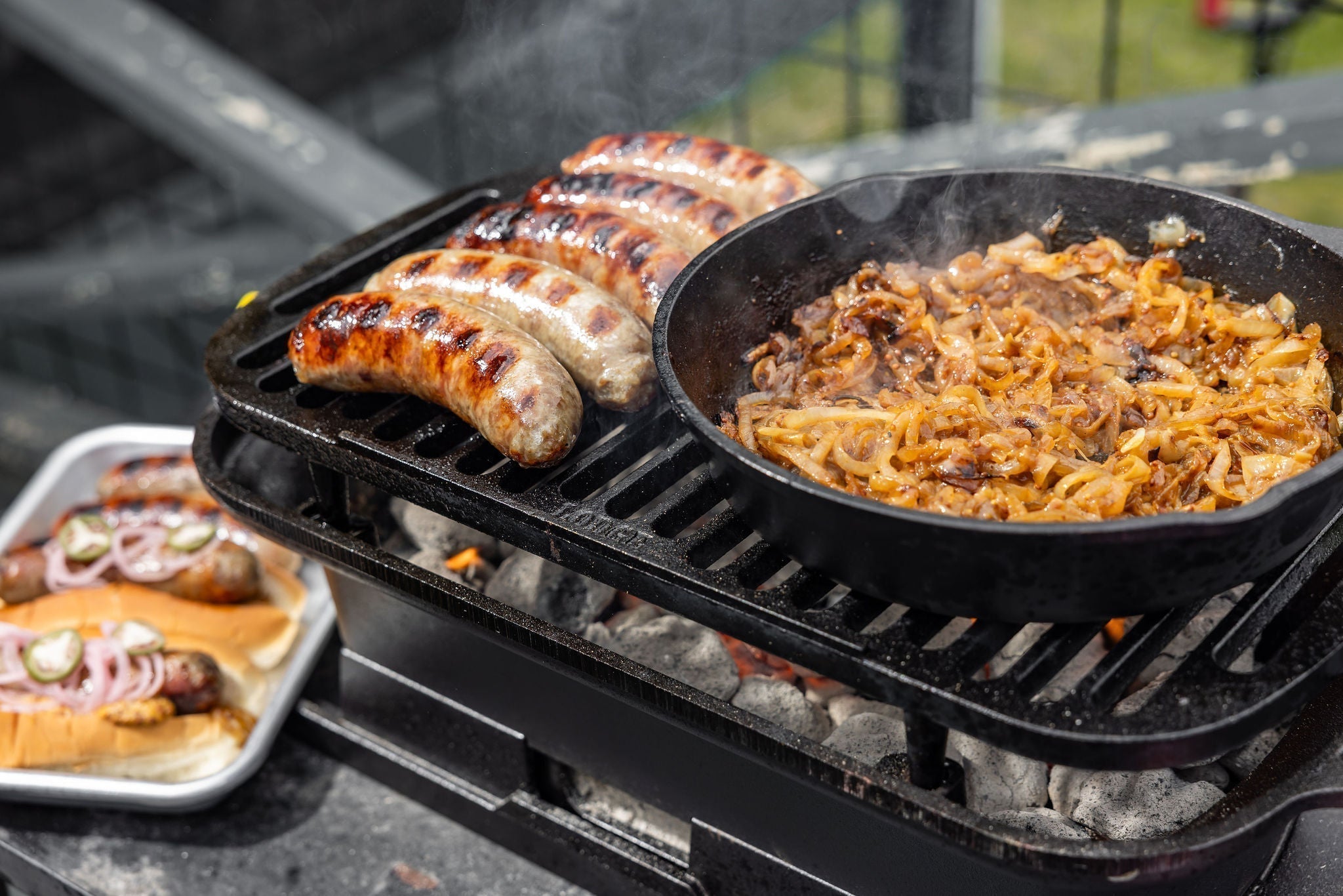 Beer brats being grilled on Sportman's Pro cast iron grill.