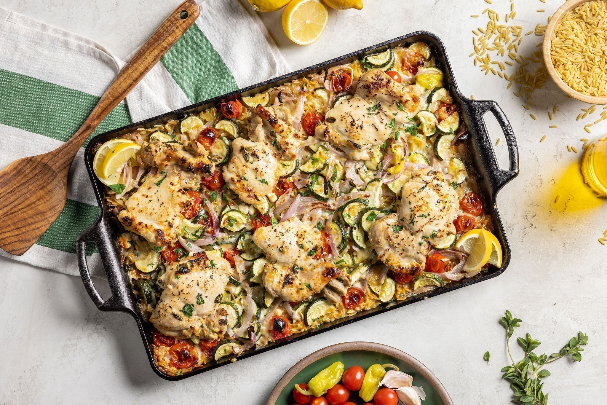 Greek chicken served on table with sheet pan