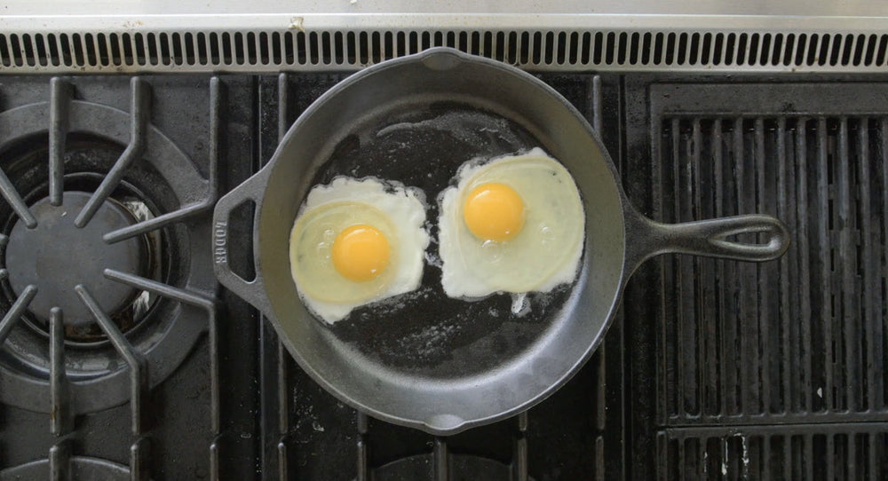 2 eggs frying in skillet