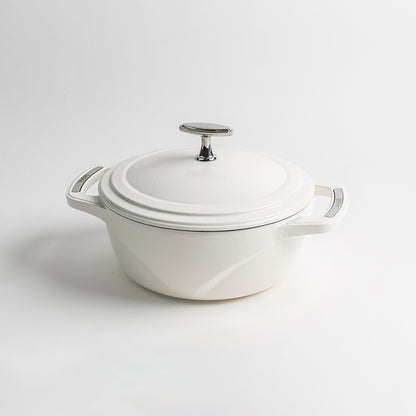 White enameled cast iron Dutch oven with a lid on a white background