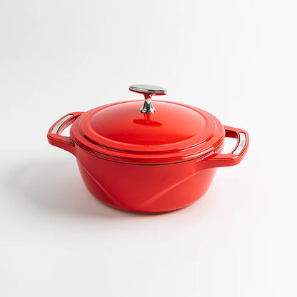 Red enameled cast iron Dutch oven with a lid on a white background