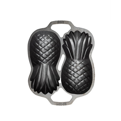 Top view of cast iron pan with 2 Pineapple-shaped molds.