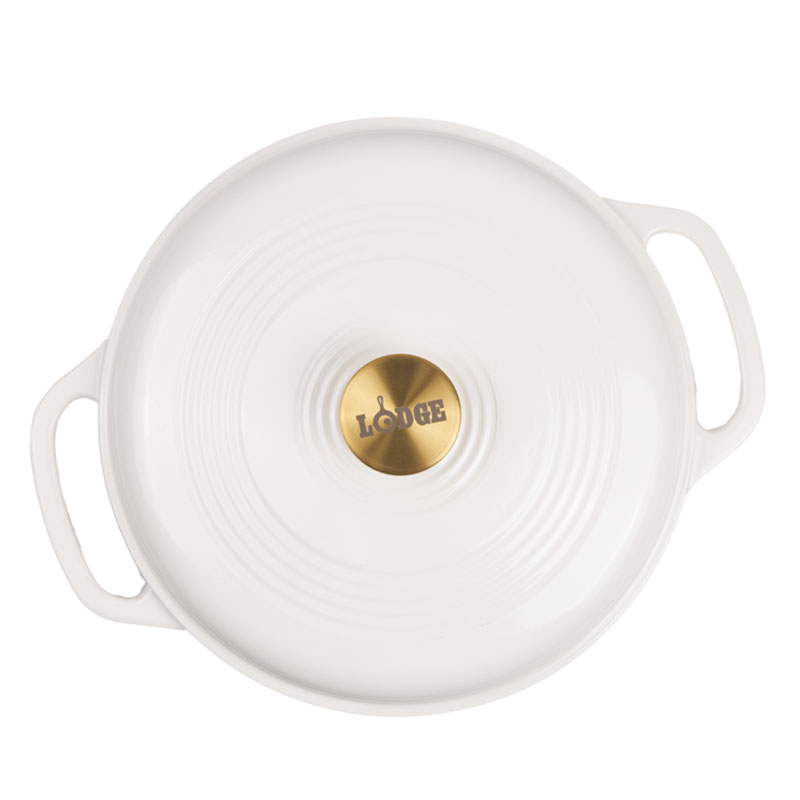 Top view of lid featuring gold knob with Lodge branding.
