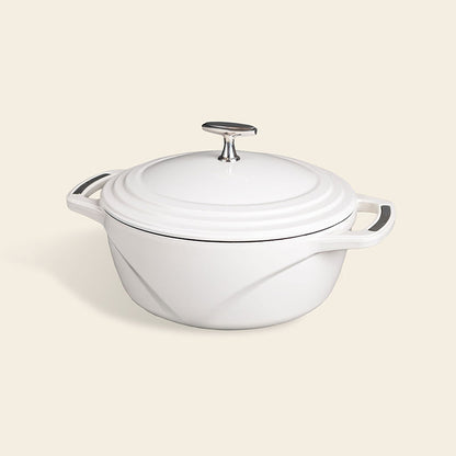 White enameled cast iron Dutch oven with a lid on a white background
