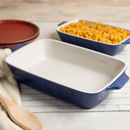 Indigo ceramic casserole dish beside freshly made Macaroni and cheese.
