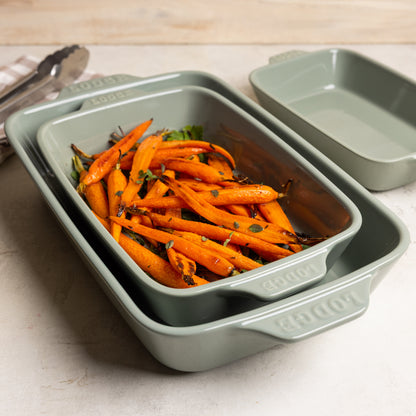 Roasted carrots in nested stoneware casserole dishes.