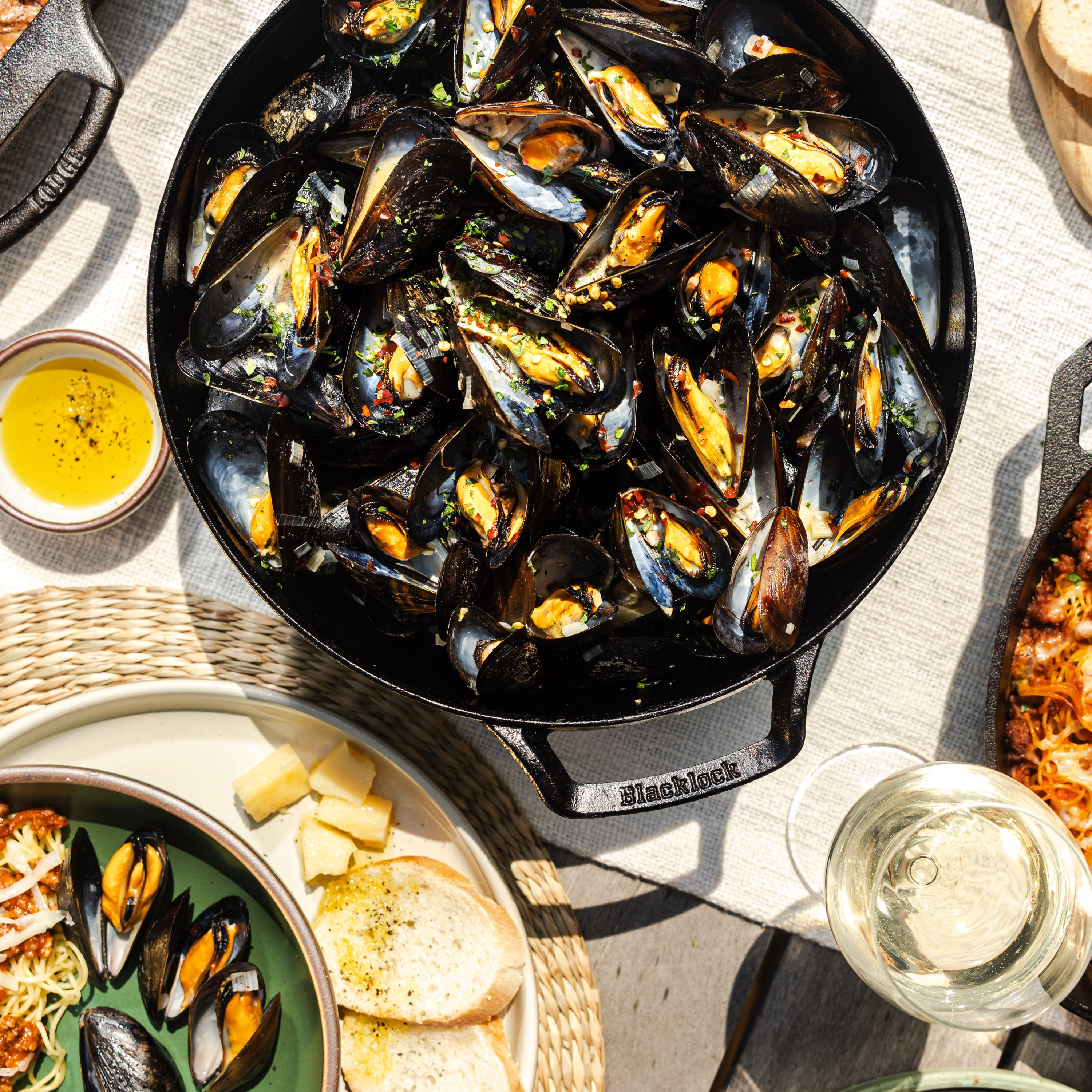 Mussels prepared and served on table with dutch oven.