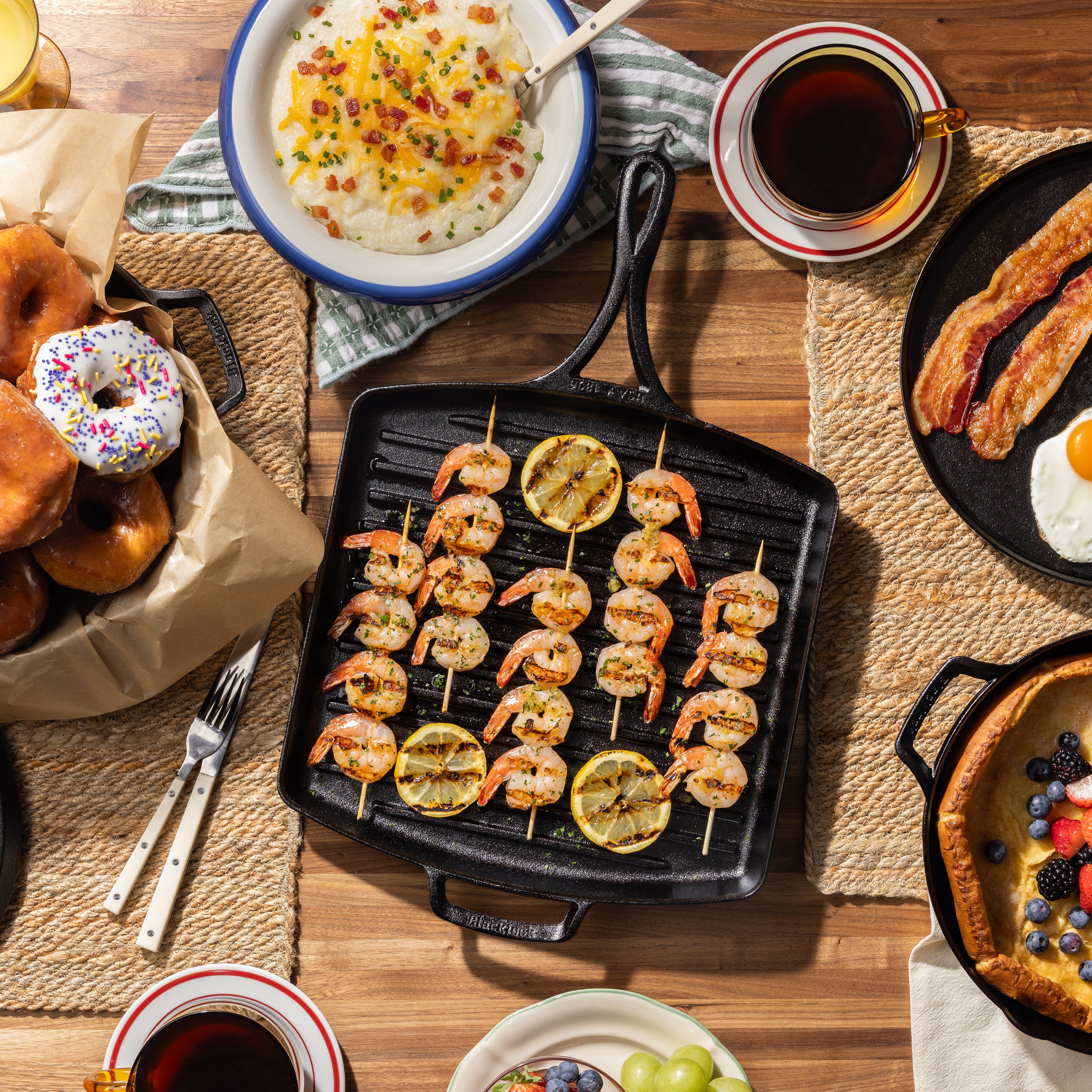 Citrus shrimp skewers served on kitchen table with pan.