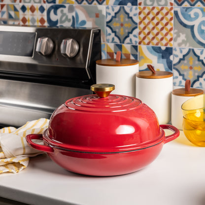 Ruby colored bread oven with a gold knob on kitchen counter.