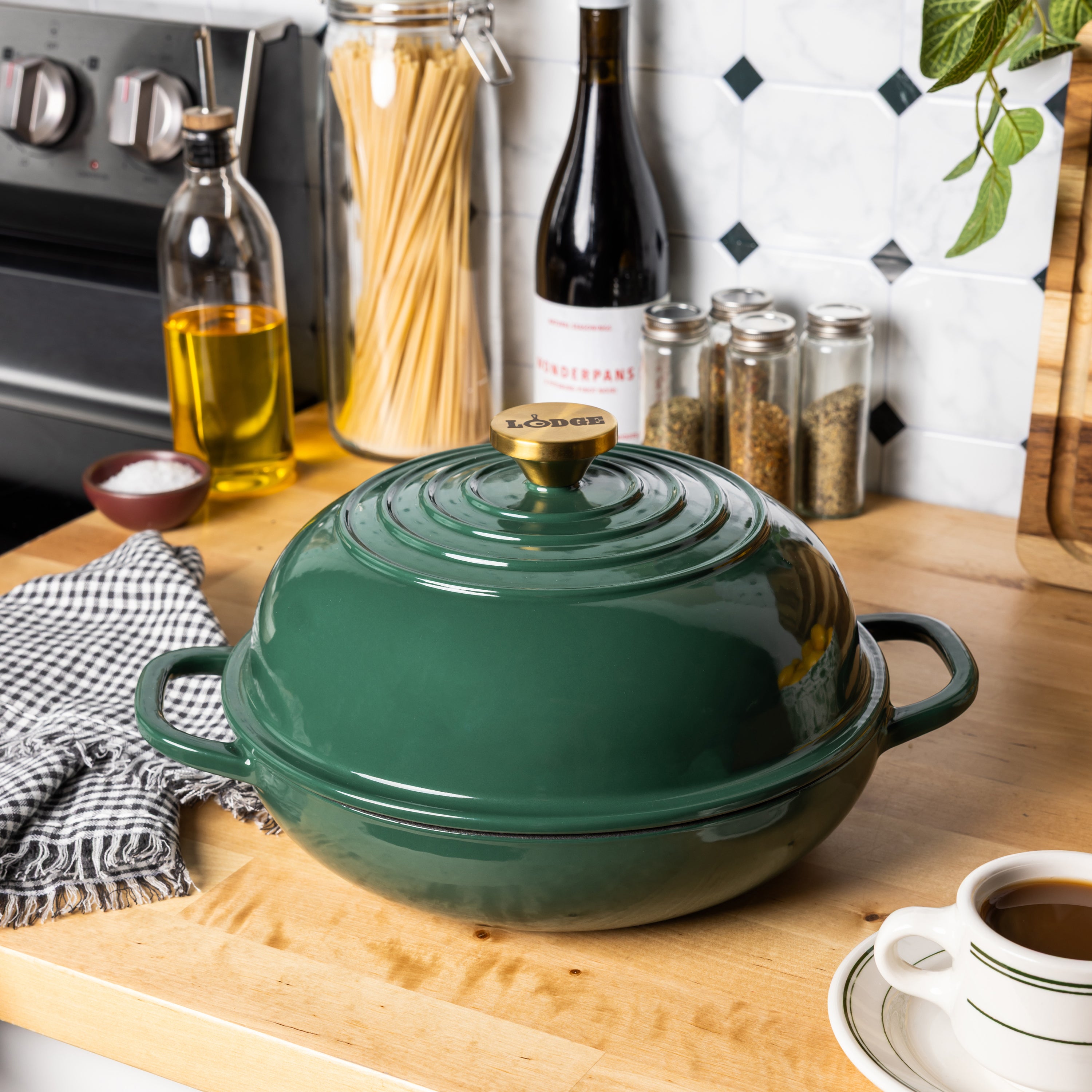 Emerald colored bread oven with a gold knob on kitchen counter.