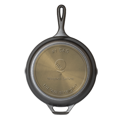 Custom skillet with an engraved icon of a golf ball on a tee including 3 editable text fields, one under neath golf ball and tee, and the others one the top and bottom arc.