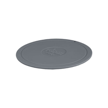 Grey circular trivet with Lodge branding in center.