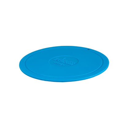 Blue circular trivet with Lodge branding in center.
