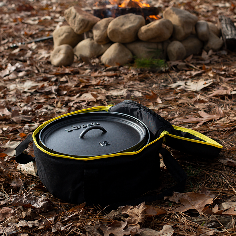 Camp dutch oven inside tote bag with top open at campsite.