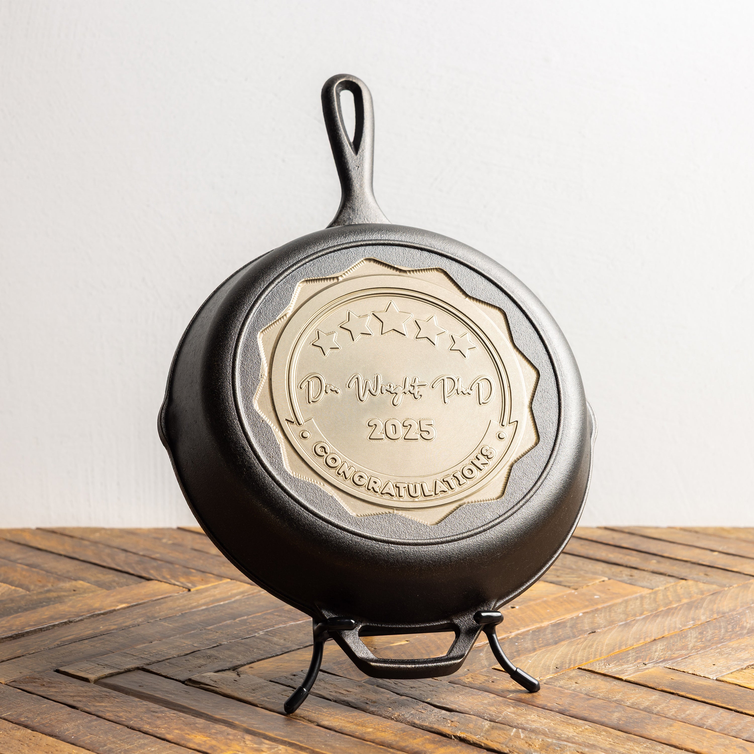 Cast iron skillet with engraved design on a wooden surface