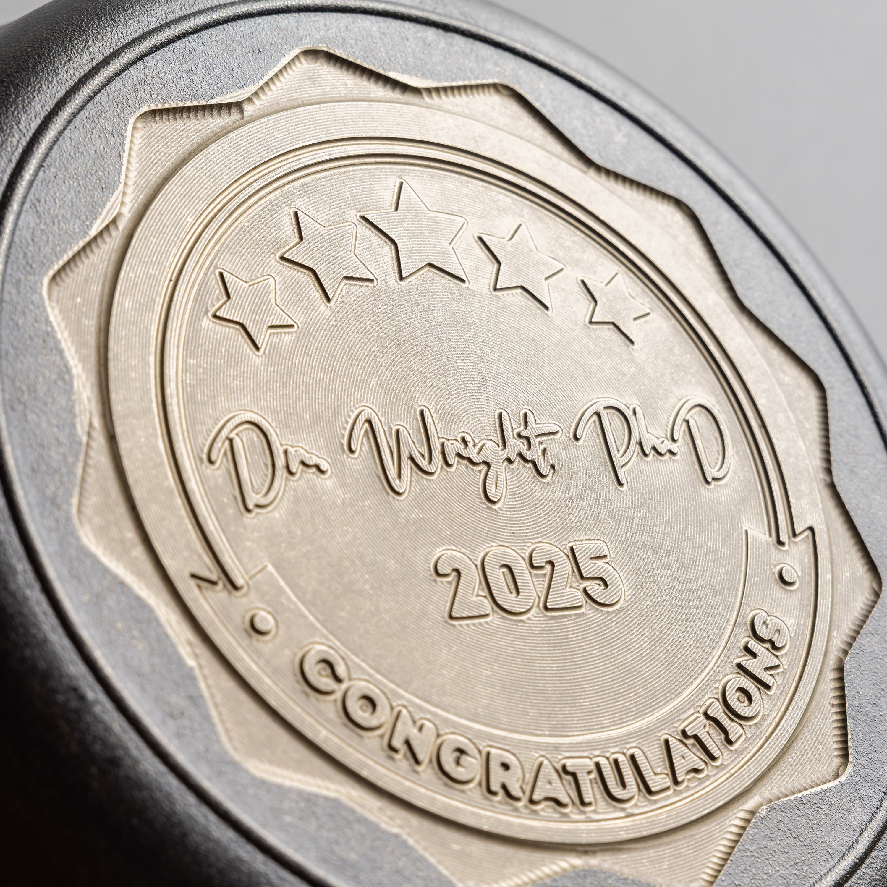 Bronze medallion with engraved text on a metallic background