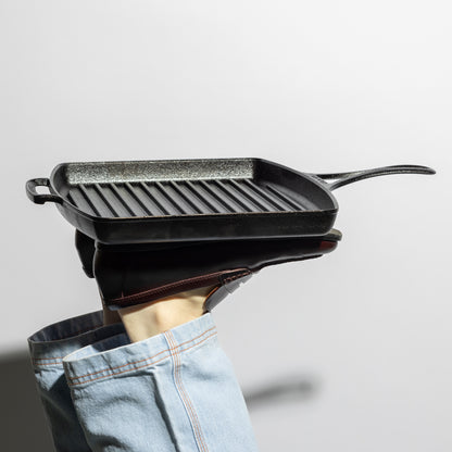Someone propping up grill pan with feet.