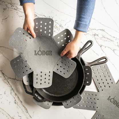 Protector being placed on skillet.
