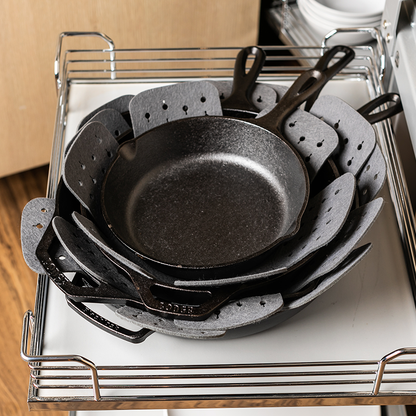 Another pile of nested skillets with protectors in between.