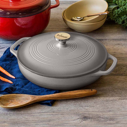Braiser on kitchen table with other cooking utensils.