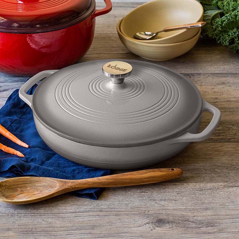 Braiser on kitchen table with other cooking utensils.