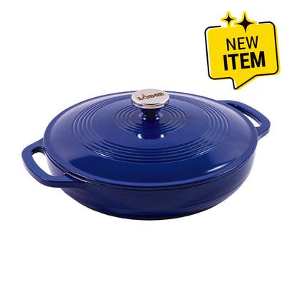 A Lodge round enameled cast iron pot with lid in a deep cobalt blue, featuring side handles and a silver-toned metal knob. A yellow 'NEW ITEM' badge is in the top right corner on a white background.