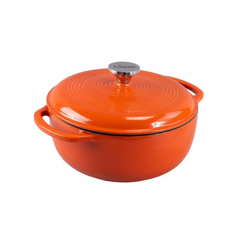 Orange enameled cast iron Dutch oven with lid on a white background