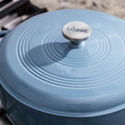 Close up of lid featuring silver knob with Lodge branding.